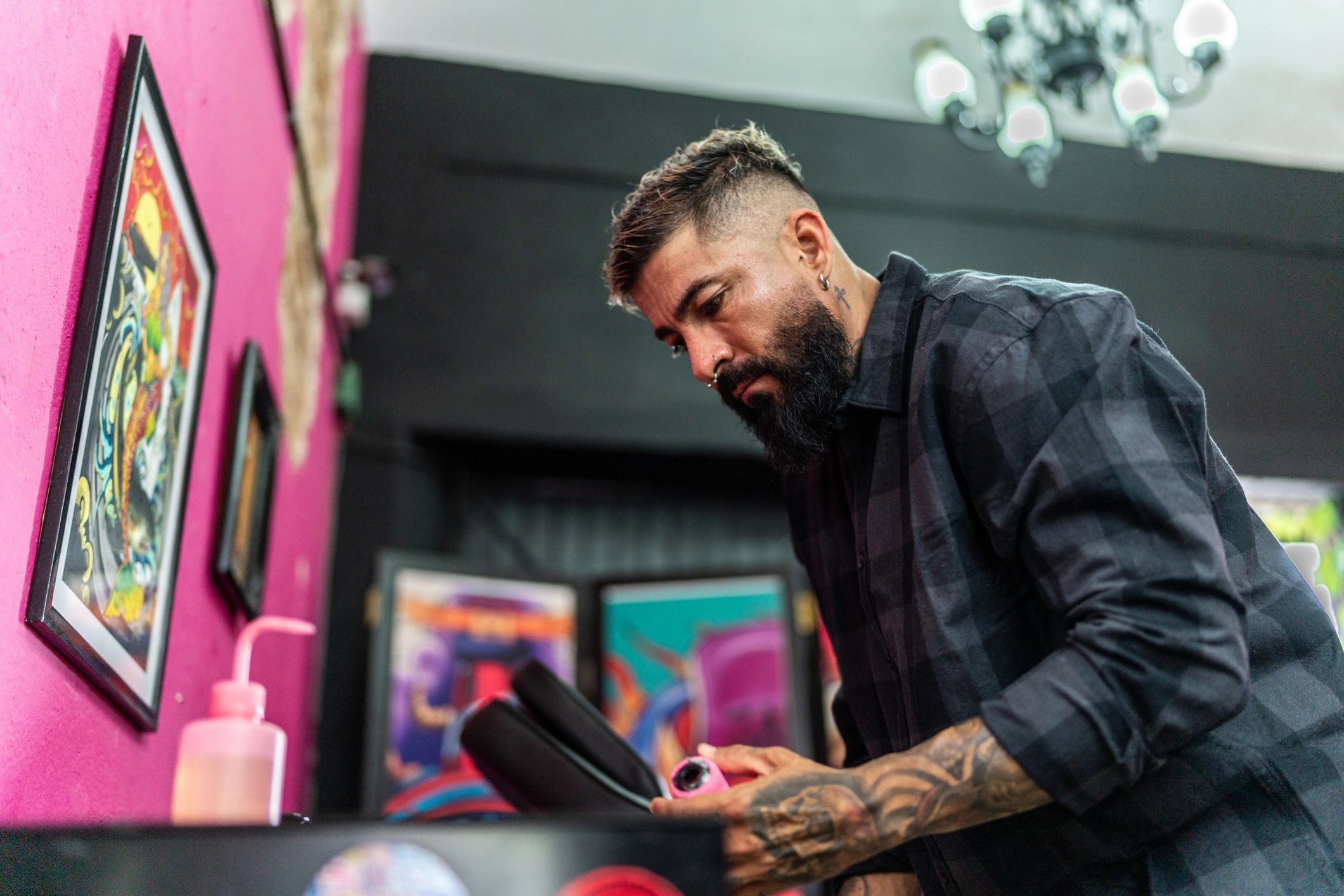 Tattoo artist preparing tools in a tattoo studio